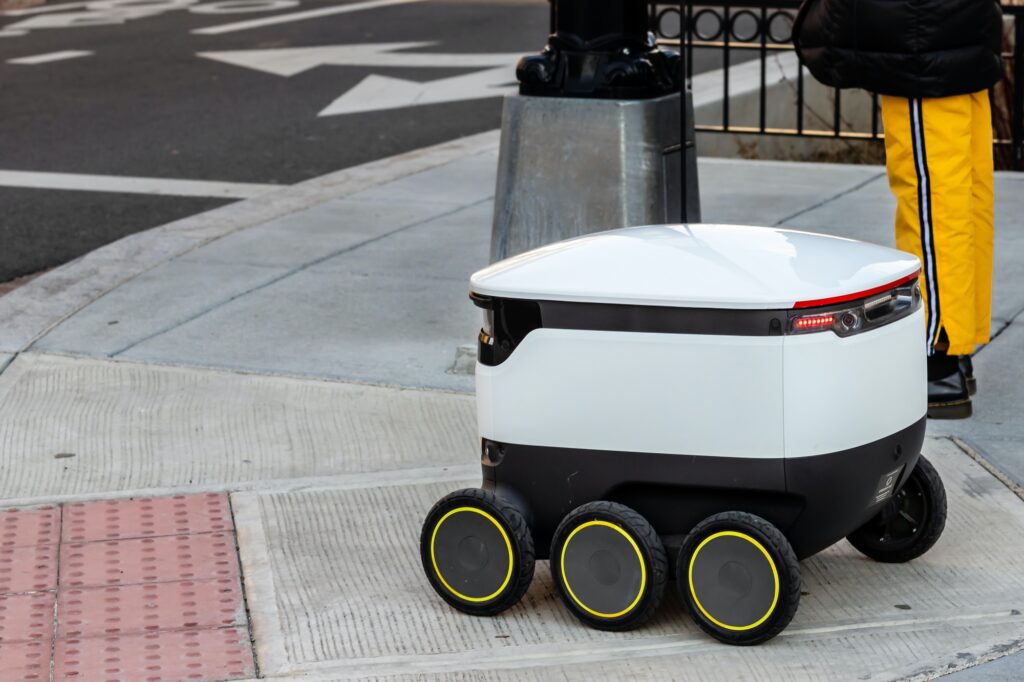 Autonomous food delivery vehicle at street crossing